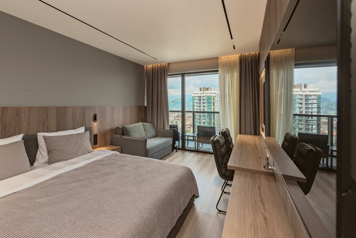 One open space: bed, sofa bed, work desk and the balcony door